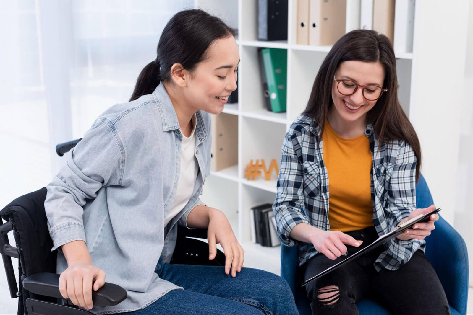Two women reviewing information together during a counseling session, representing partial hospitalization (PHP), intensive outpatient programs (IOP), structured therapy, and continued support after residential rehab.